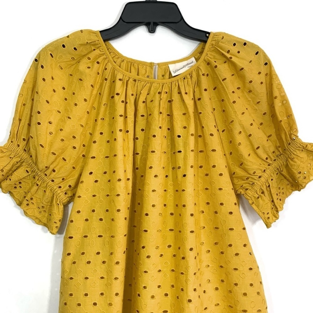 Golden eyelet shirt with little bit of puffy sleeves.